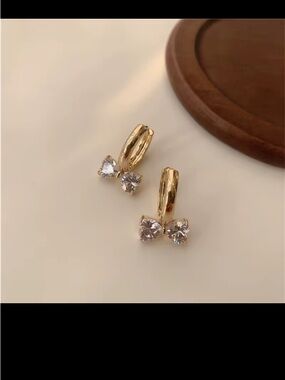 Gold Huggie Earrings with Clear Crystal Bow Accents